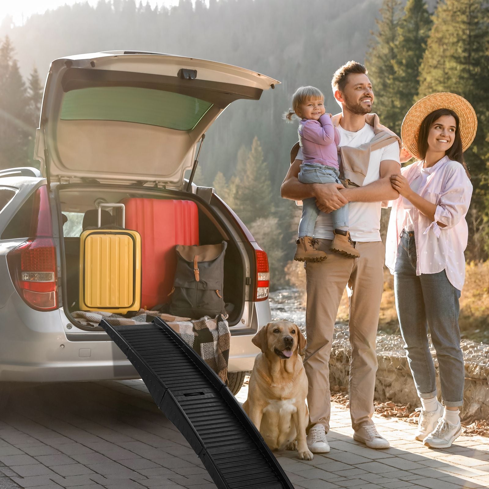 Family and dog beside a TrailRamp at an open SUV in an outdoor setting