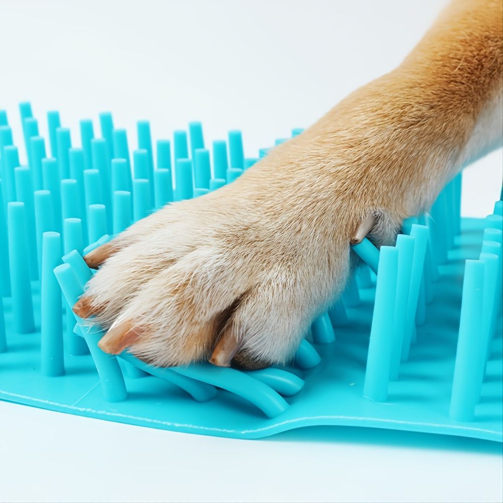 Dog paw positioned near the flexible blue MudErase insert